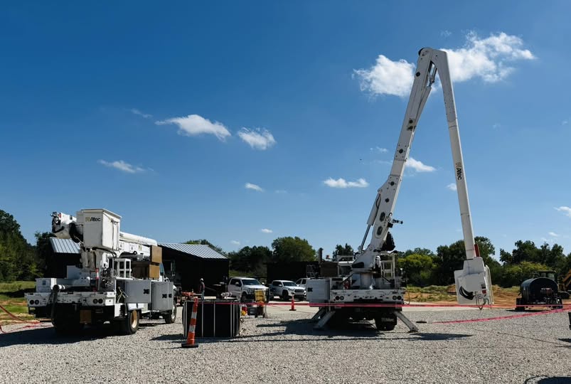 Utility bucket trucks set up in a marked work area